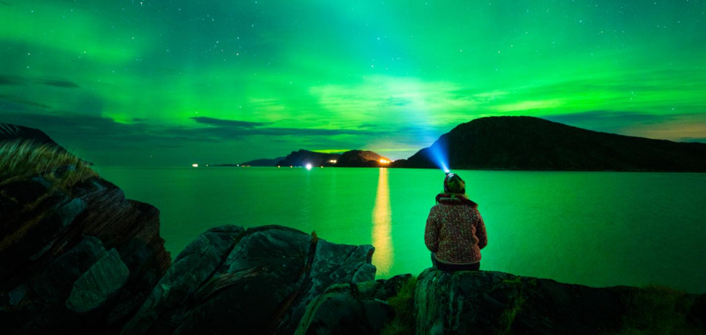 Enjoying the norhtern lights from a beach