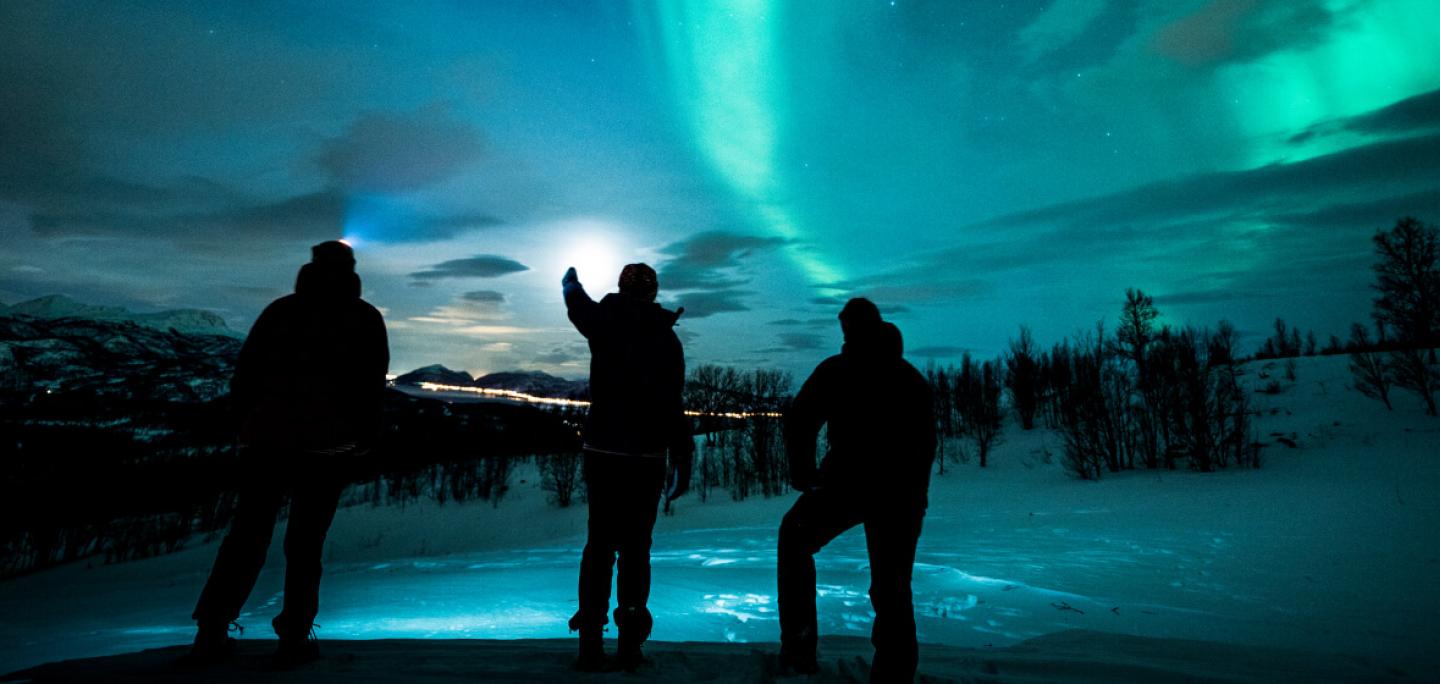 Watching the northern lights in Arctic winter landscape