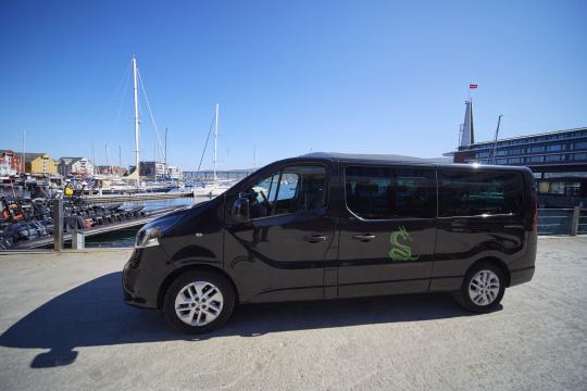 Van with logo parked be the harbor.