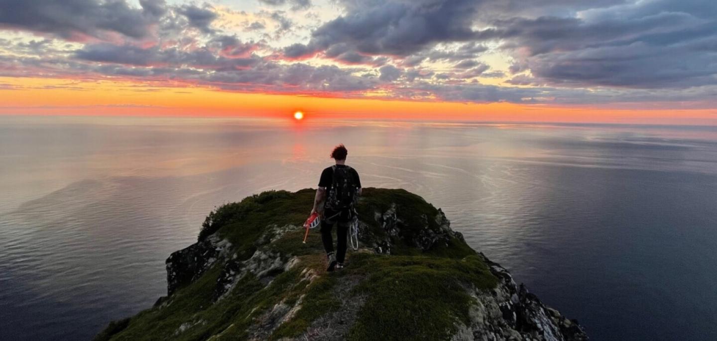 man on top of a mountain watching the sunset Legendary Adventure 