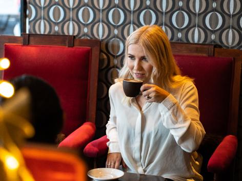 Girl enjoying a coffee at a café in Tromsø