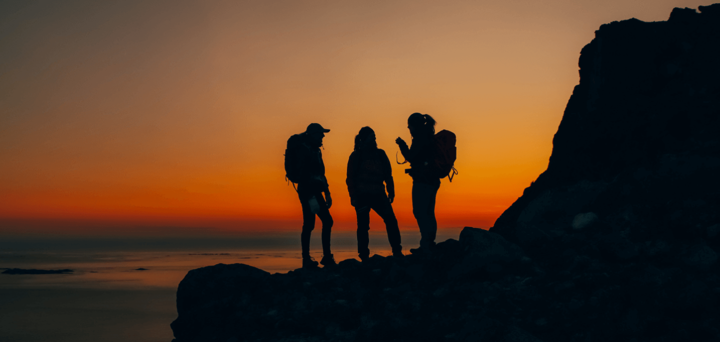 Silhouettes on a mountain top in sunset